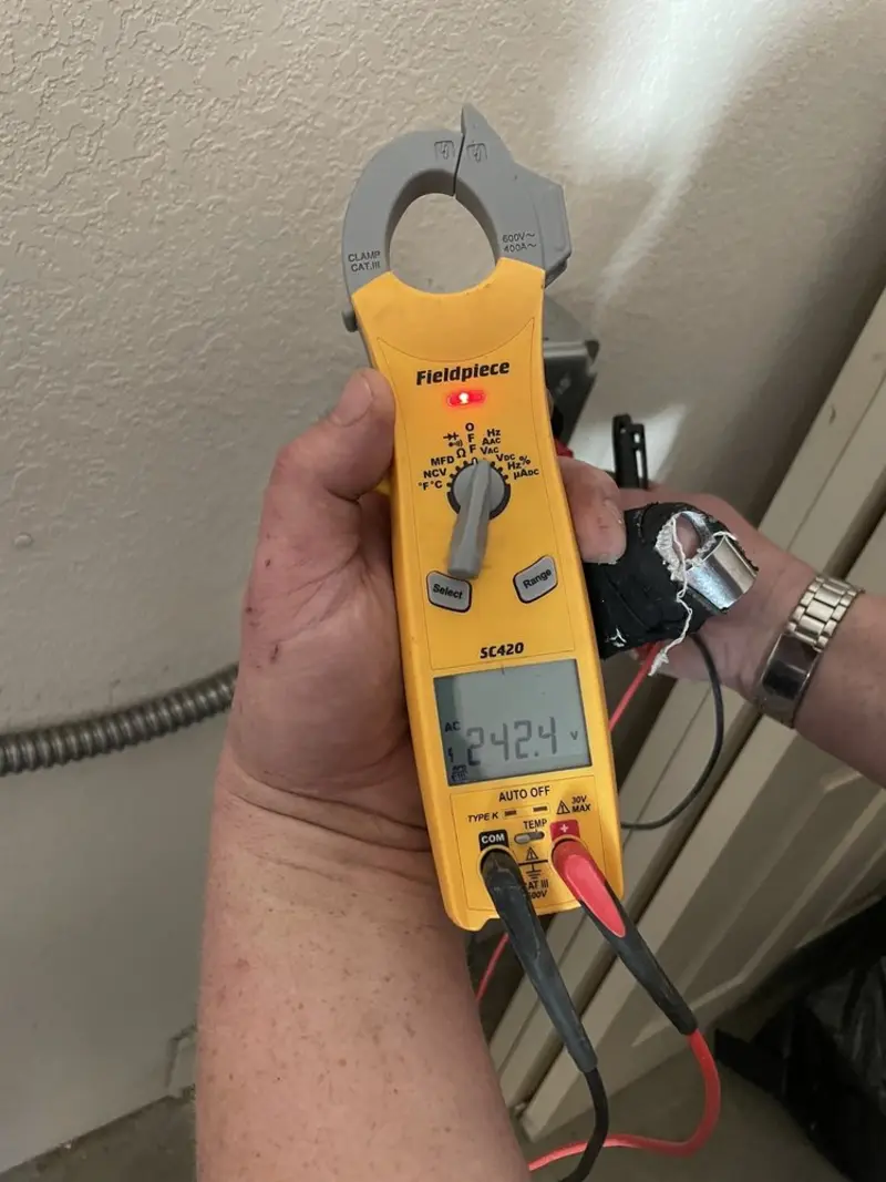 Voltage testing with clamp meter during Whole House Surge Protector in Scarsdale